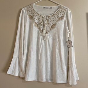 Beautiful, flowy, white top with bell sleeves and tasseled tie front at the neck
